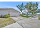 Garage exterior shows a two-car garage with driveway, landscaping, and an attractive lawn at 150 Reef Rd, South Daytona, FL 32119