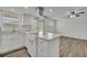 An open-concept kitchen with an island, stainless hood, and modern appliances at 150 Reef Rd, South Daytona, FL 32119