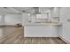 Modern kitchen with bright white cabinets, stainless steel appliances, and a breakfast bar at 150 Reef Rd, South Daytona, FL 32119