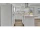 Bright kitchen featuring white cabinets, modern appliances, and wood-look flooring at 150 Reef Rd, South Daytona, FL 32119