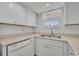 Kitchen area featuring white cabinets, stainless steel appliances, and ample natural light at 150 Reef Rd, South Daytona, FL 32119