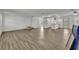 Spacious open-concept living room with modern flooring flowing into a bright white kitchen at 150 Reef Rd, South Daytona, FL 32119