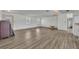 Open living area with wood-look flooring, white walls, and ample space for furniture arrangement at 150 Reef Rd, South Daytona, FL 32119