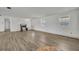 Bright living room with wood-look floors, white walls, and natural light from windows at 150 Reef Rd, South Daytona, FL 32119