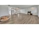 Spacious living room with wood-look flooring and a bright, open floor plan leading to the kitchen at 150 Reef Rd, South Daytona, FL 32119