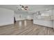 Open living area featuring modern flooring, a ceiling fan, and a seamless transition to the kitchen at 150 Reef Rd, South Daytona, FL 32119