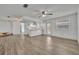 Open-concept living space showcasing modern flooring flowing into a kitchen with bright white cabinets at 150 Reef Rd, South Daytona, FL 32119