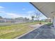 View of patio and backyard with a chainlink fence and an outdoor grill at 150 Reef Rd, South Daytona, FL 32119