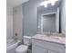 Bathroom featuring a white vanity with a granite countertop and tub at 1598 Montgomery Ave, Daytona Beach, FL 32117