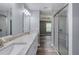 Bathroom with double sink vanity, granite countertops, and glass shower at 1598 Montgomery Ave, Daytona Beach, FL 32117