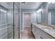 Bathroom featuring double sinks, granite countertops, a glass enclosed shower and walk-in closet at 1598 Montgomery Ave, Daytona Beach, FL 32117
