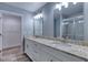 Bright bathroom with double vanity, granite countertops, and a glass enclosed shower at 1598 Montgomery Ave, Daytona Beach, FL 32117