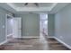 Bedroom leading into the connected bathroom, featuring wood-look floors at 1598 Montgomery Ave, Daytona Beach, FL 32117