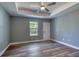 Spacious bedroom with a tray ceiling, wood-look floors, and a large window at 1598 Montgomery Ave, Daytona Beach, FL 32117