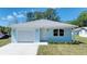 Charming single-story home boasts a single-car garage, manicured lawn, and fresh siding at 1598 Montgomery Ave, Daytona Beach, FL 32117