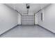 A clean garage featuring sealed epoxy floor and paneled door at 1598 Montgomery Ave, Daytona Beach, FL 32117