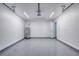 Garage interior with sealed epoxy floor, utility door, and water heater at 1598 Montgomery Ave, Daytona Beach, FL 32117