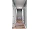 Neutral colored hallway with multiple doors and laminate flooring at 1598 Montgomery Ave, Daytona Beach, FL 32117