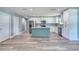 Bright open kitchen featuring white cabinets, stainless steel appliances, an island and modern flooring at 1598 Montgomery Ave, Daytona Beach, FL 32117