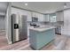 A spacious kitchen featuring an island, stainless appliances, modern cabinets, and granite countertops at 1598 Montgomery Ave, Daytona Beach, FL 32117