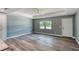 A bright living room showcases modern hard wood floors, a ceiling fan and fresh paint at 1598 Montgomery Ave, Daytona Beach, FL 32117