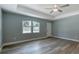 Bright living room featuring modern flooring, a ceiling fan, fresh paint, and a window at 1598 Montgomery Ave, Daytona Beach, FL 32117