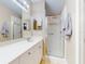 Bathroom featuring a single sink, vanity lights, and a walk-in shower at 161 Blue Heron Dr # C, Daytona Beach, FL 32119