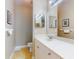 Bathroom featuring a single sink, vanity lights, and a toilet at 161 Blue Heron Dr # C, Daytona Beach, FL 32119