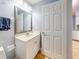 Updated bathroom features vanity with countertop and single sink, framed mirror, and white cabinets at 161 Blue Heron Dr # C, Daytona Beach, FL 32119