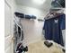 Walk-in closet with shelving, hanging space, and personal items at 161 Blue Heron Dr # C, Daytona Beach, FL 32119