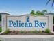Pelican Bay community sign, a welcoming entrance feature with manicured flower beds at 161 Blue Heron Dr # C, Daytona Beach, FL 32119