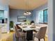 Modern dining room featuring a modern table and chairs with unique overhead lighting at 161 Blue Heron Dr # C, Daytona Beach, FL 32119