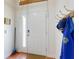 Bright entryway with coat rack, white door, and warm-toned tile flooring at 161 Blue Heron Dr # C, Daytona Beach, FL 32119