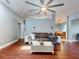 Spacious living room with wood floors, a large sofa, and a view into the dining area and office at 161 Blue Heron Dr # C, Daytona Beach, FL 32119