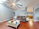 Inviting living room featuring wood floors, a comfortable sofa, and a partial view of the dining area at 161 Blue Heron Dr # C, Daytona Beach, FL 32119