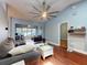 Open living room featuring hardwood floors, a ceiling fan, and modern decor at 161 Blue Heron Dr # C, Daytona Beach, FL 32119