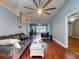 Open living room with wood flooring, a large ceiling fan, and lots of natural light at 161 Blue Heron Dr # C, Daytona Beach, FL 32119