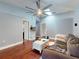 Living room with wood floors, a skylight, and a comfortable sofa at 161 Blue Heron Dr # C, Daytona Beach, FL 32119
