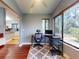 Bright office space with large windows overlooking the fenced backyard and wood flooring at 161 Blue Heron Dr # C, Daytona Beach, FL 32119