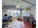 Office space with large windows, wood floors, ceiling fan, and shelving units at 161 Blue Heron Dr # C, Daytona Beach, FL 32119