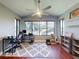 Well-lit office featuring large windows, a ceiling fan, wood floors, and a patterned rug at 161 Blue Heron Dr # C, Daytona Beach, FL 32119
