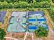Aerial view of tennis courts, showcasing the layout and surrounding greenery at 161 Blue Heron Dr # C, Daytona Beach, FL 32119