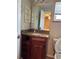 Bathroom featuring a wooden vanity with a granite countertop and framed mirror at 1649 Courtland Blvd, Deltona, FL 32738