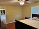 Bedroom features natural light from the window, ceiling fan, and wood-look flooring at 1649 Courtland Blvd, Deltona, FL 32738