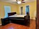Bedroom features natural light from the window, ceiling fan, wood-look flooring and closet at 1649 Courtland Blvd, Deltona, FL 32738