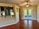 Dining room features wood-look floors, ceiling fan, and glass doors to a patio at 1649 Courtland Blvd, Deltona, FL 32738