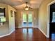 Dining room features wood-look floors, ceiling fan, and glass doors to a patio at 1649 Courtland Blvd, Deltona, FL 32738