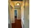 Bright hallway features hardwood floors, fresh paint, and access to bedrooms and closet space at 1649 Courtland Blvd, Deltona, FL 32738