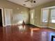 Living room with wood-look floors, bay window, and front door at 1649 Courtland Blvd, Deltona, FL 32738