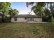 Spacious backyard with ample green space and a patio, perfect for outdoor activities at 1731 Urbana Ave, Deltona, FL 32725